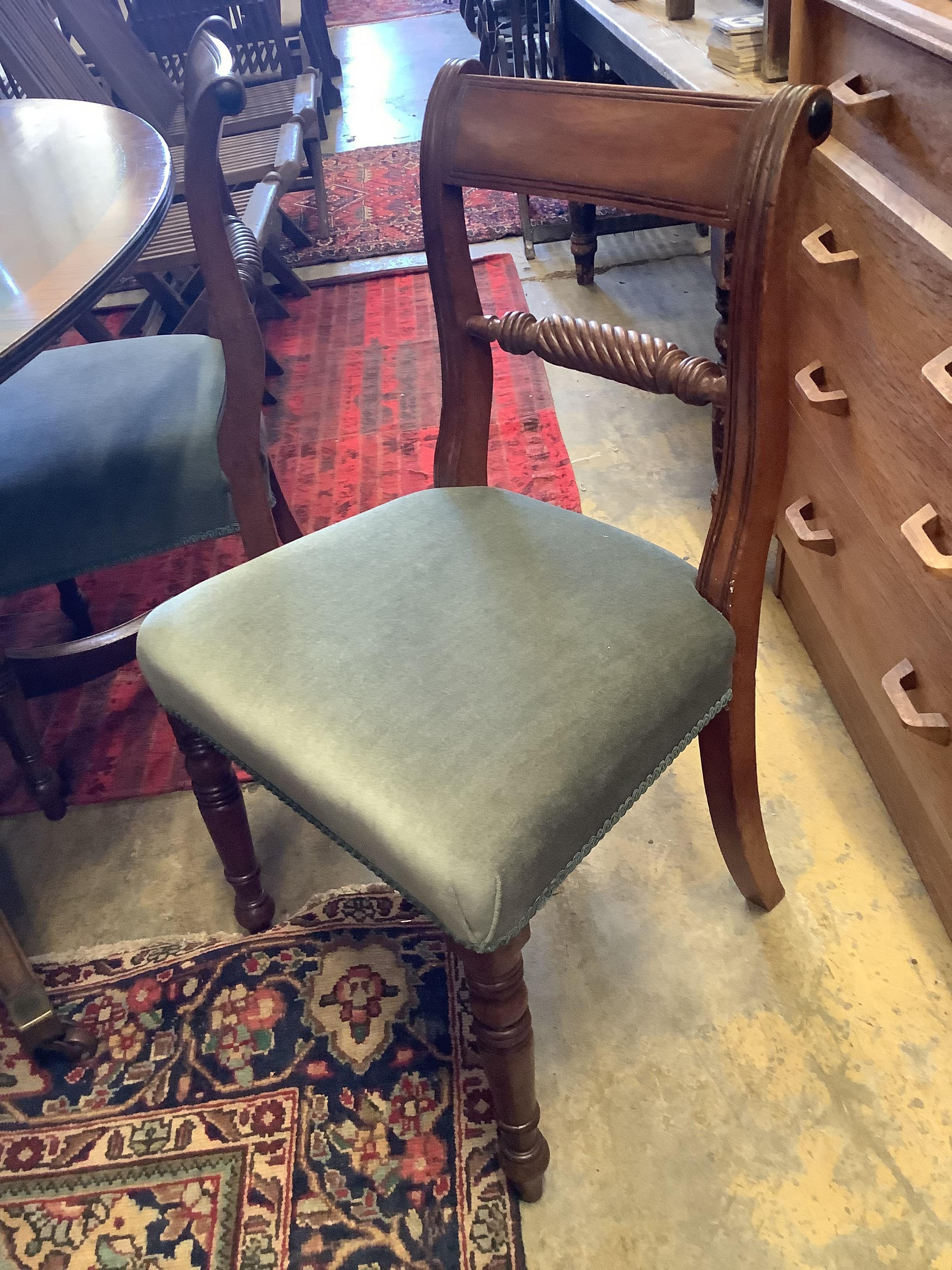 An associated set of six 19th century dining chairs in the Regency style, two with arms